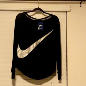 Women’s Nike size small NWT, black long sleeve shirt w Silver Nike symbol.